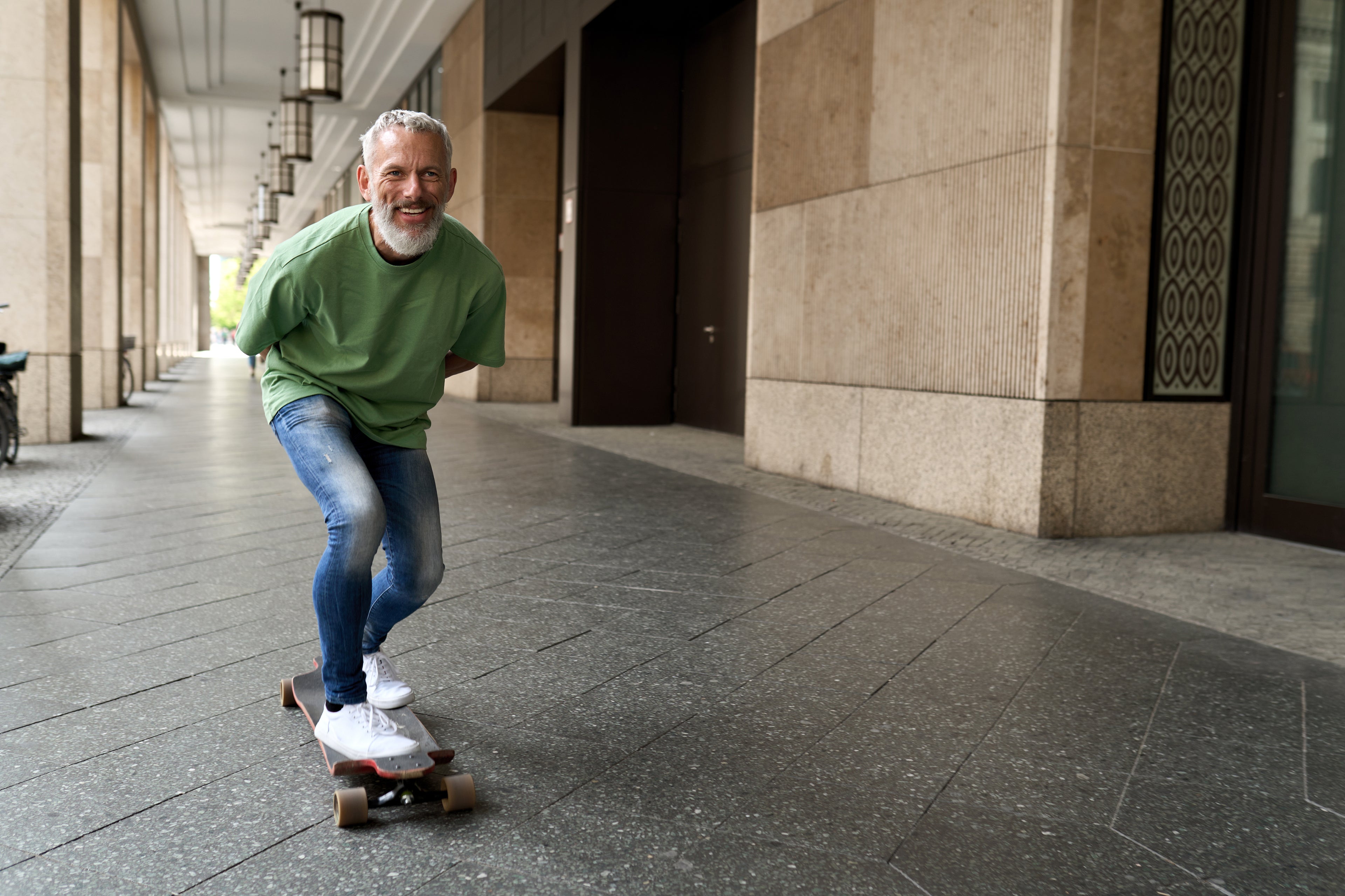 BetterDry Pull-Ons give you light protections for occasional accidents. Carry on being awesome! Here a man is skateboarding down a corridor looking confident and free.